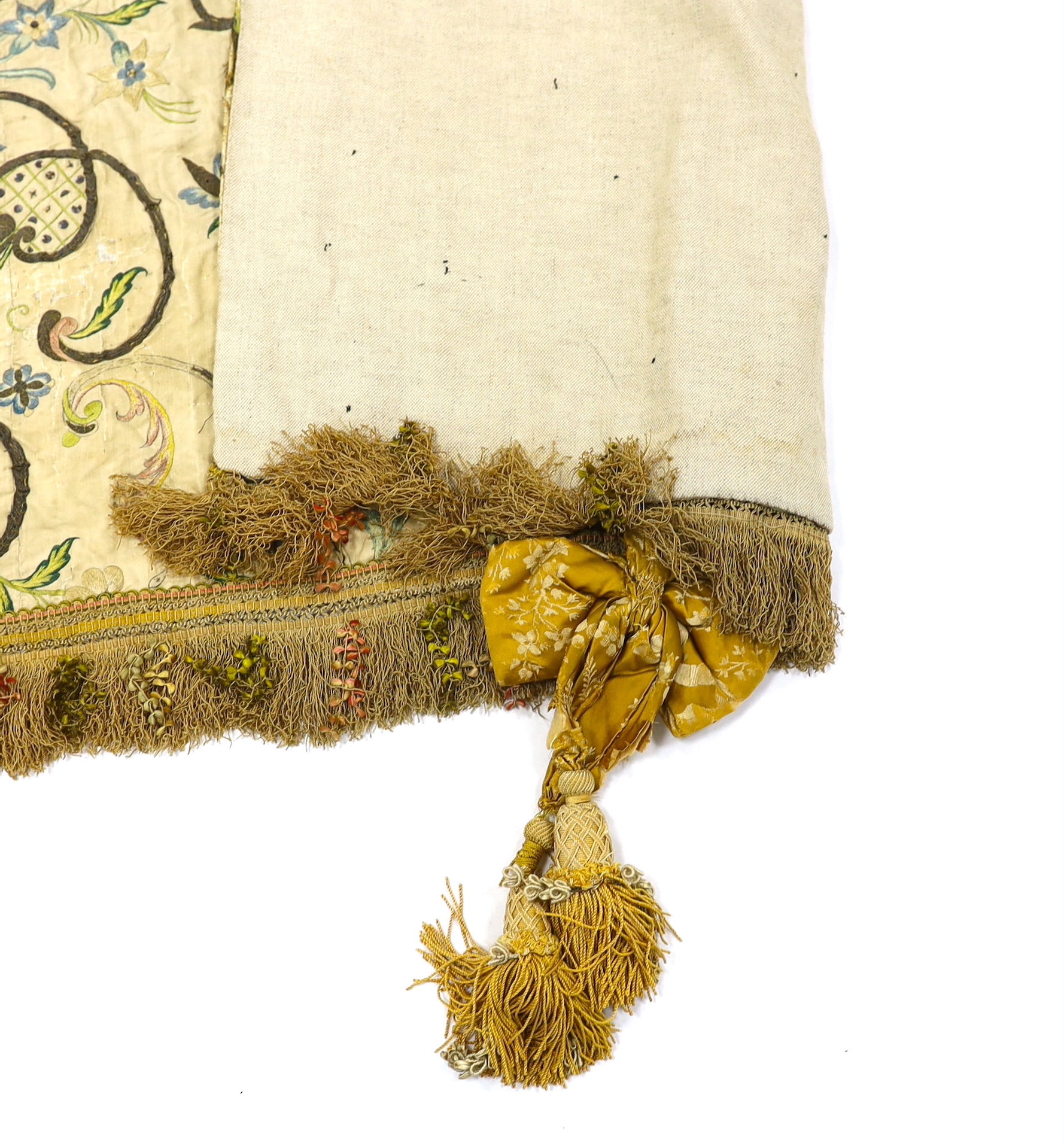 A mid-18th century Continental silk embroidered altar cloth, embroidered with polychrome silks and silver metallic threads in an all-over floral design on cream silk with ornate silk tasselling, (the damask tie backs add
